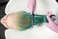 Top View of Hairdresser Holds Hair in Hand and Combs Long Green Hair While Washing Hair in Shower - PhotoDune Item for Sale