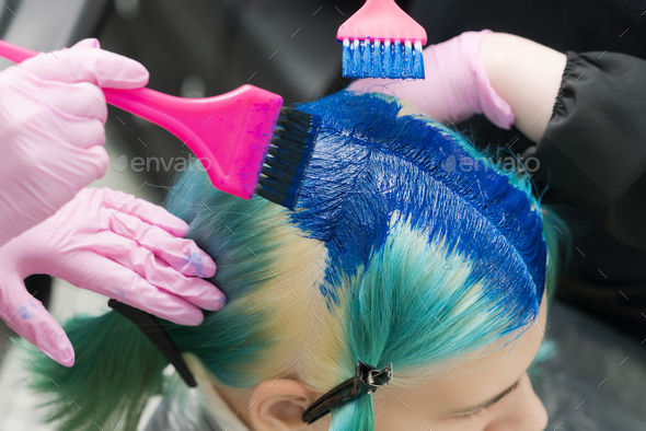 Hairdressers Using Brush While Applying Blue Paint to Female Emerald Hair  Color. Process Dyeing Hair Stock Photo by Kamchatka