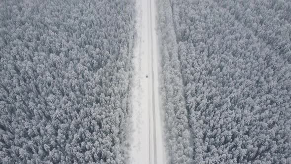 Aerial Top View From Drone Birds Eye View of Winter Landscape and Snowy Ice Road Car Moving on Area