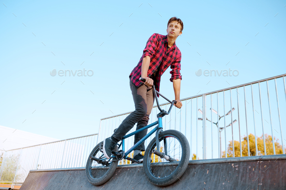Bmx biker doing trick,teenager in skatepark