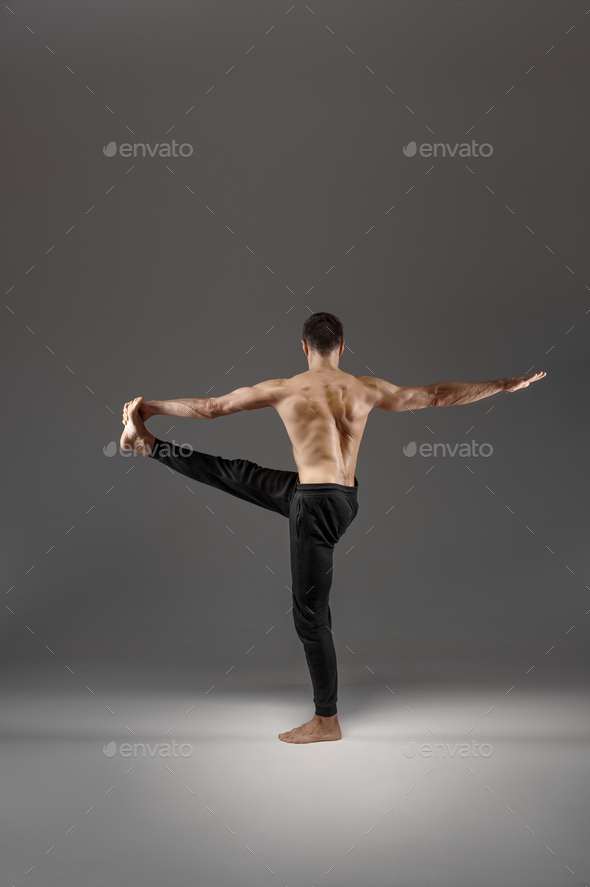 Muscular Yoga Doing Stretching Exercise In Studio Stock Photo By Nomadsoul1