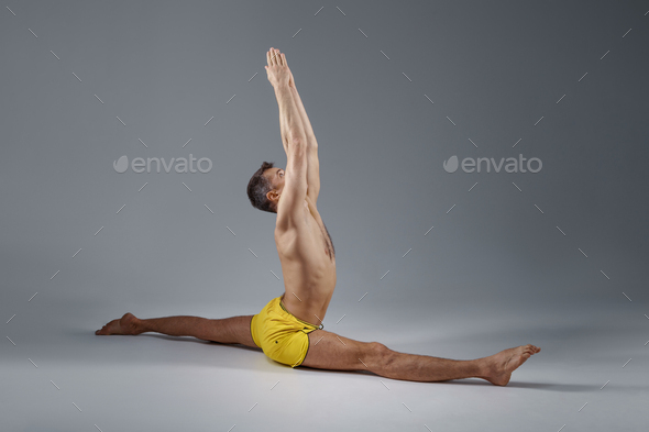 Male yoga sits on a twine, relaxation position