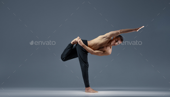 Wall Mural Flexible man posing in difficult yoga pose - PIXERS.US