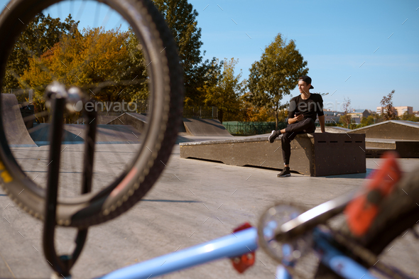 Male bmx rider poses in skatepark at the bike