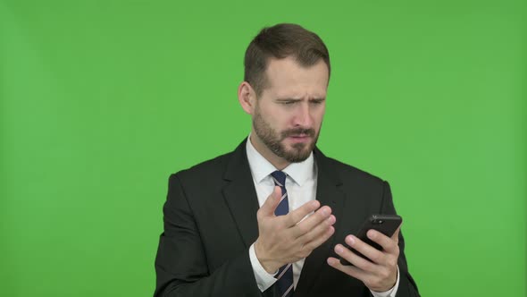 Businessman Get Disappointed While Using His Phone Against Chroma Key alt