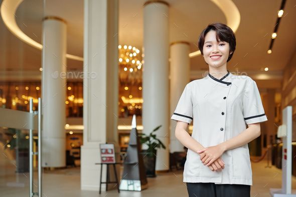 Pretty concierge in hotel uniform