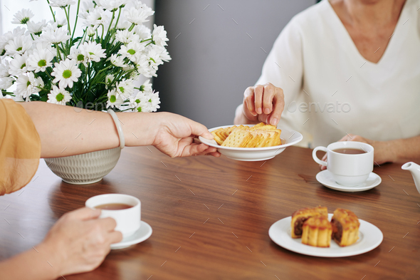 Woman offering plate with cookies