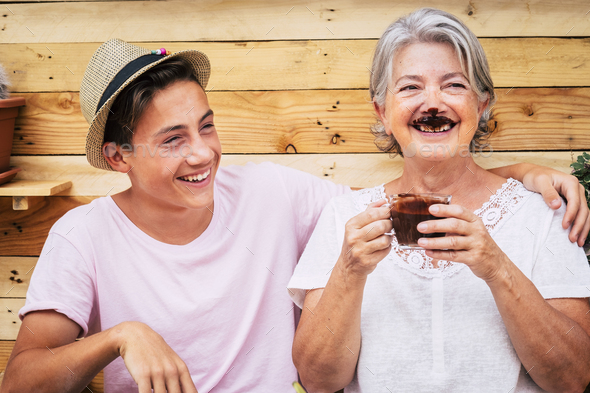 beautiful couple of people having fun and joking together with a grandma drinking hot chocolate