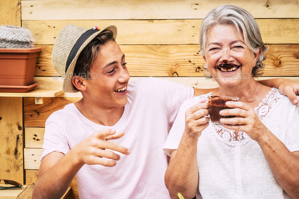 beautiful couple of people having fun and joking together with a grandma drinking hot chocolate