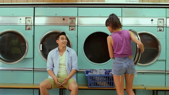 A Young Man and a Young Woman meet in a Launderette whilst doing their laundry