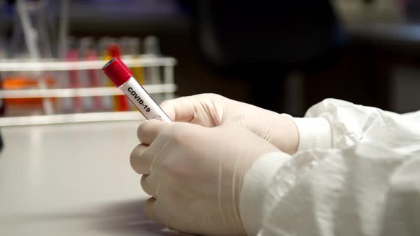 Scientist Holding COVID-19 Test Tube