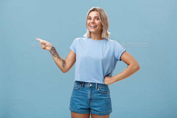 Serious girl dancer stands raising her left hand looking directly at the  camera. Front view. Stock Photo by ©gearstd 105289716