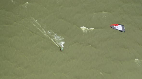 AERIAL: Extreme Water Sport and Summer Vacations Concept - Professional Kite Surfer on the Sea Wave alt