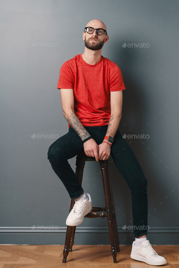 Man in Black Crew Neck Shirt Sitting on Metal Bench · Free Stock Photo