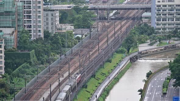 time lapse of traffic bridge with car, train, and people in Shenzhen, China