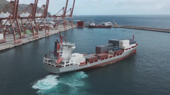 A Cargo Ship with Containers Enters the Port for Unloading. alt