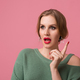young attractive woman in green sweater, pink background - PhotoDune Item for Sale