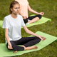 Two young slim girls sit in the lotus positions with closing eyes