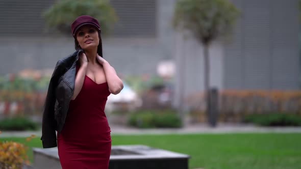 a Beautiful Business-like Confident Woman in a Purple Cap, Wearing a Leather Jacket, Under Which a alt