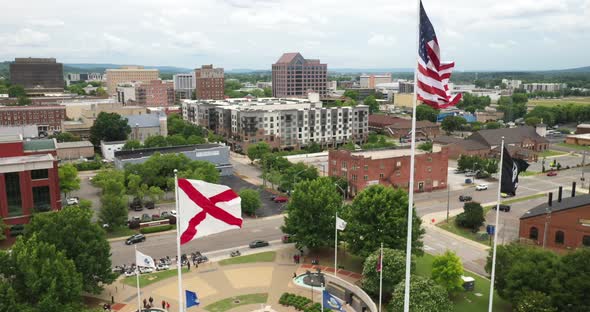 Huntsville, Alabama skyline with Alabama state flag and United States of America flag flying. alt