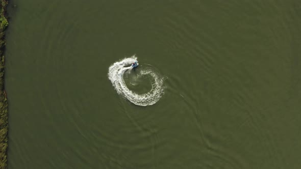 Overhead view of someone jet skiing and doing doughnuts in the Delta in Antioch Northern California alt