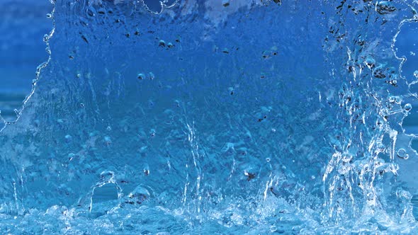 Super Slow Motion Shot of Ripping Blue Water Splash at 1000Fps alt
