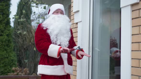 Side View Burglar in Red Costume with White Beard Looking Around Breaking in House alt