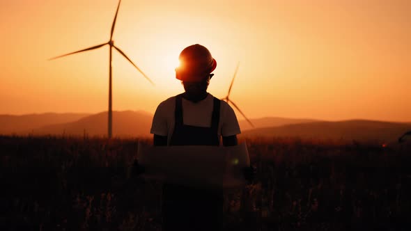 Silhouette African American Man with Blueprints in Hands Standing Among Farm alt