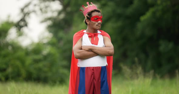 Hero man in red with crown standing and crossing arms alt