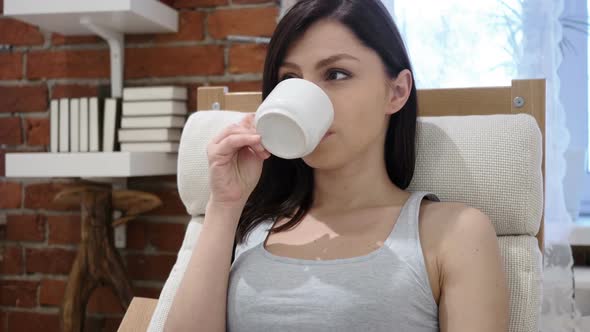 Portrait of Young Woman Drinking Coffee From Cup alt