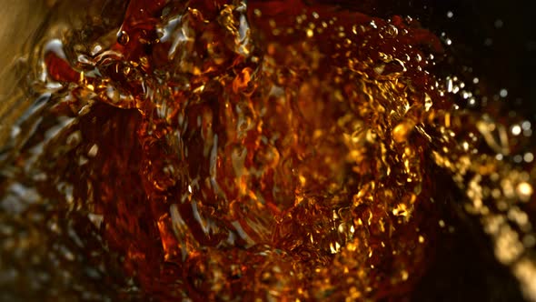 Super Slow Motion Abstract Shot of Pouring Brown Liquid in Glass Bottle at 1000 Fps alt