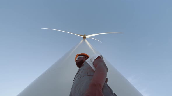 Smiling Engineer Near Wind Turbines Develop Ecological Energy Gesturing Thumb Up alt
