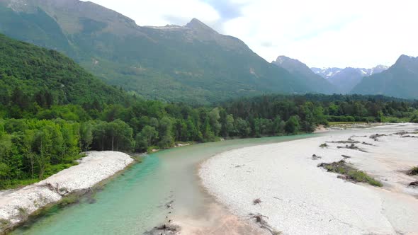 Aerial view of river with mountains in background. Soca river near Bovec, Slovenia. alt