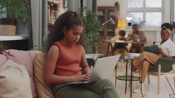 10-Year-Old Afro Girl Studying On Laptop From Home alt