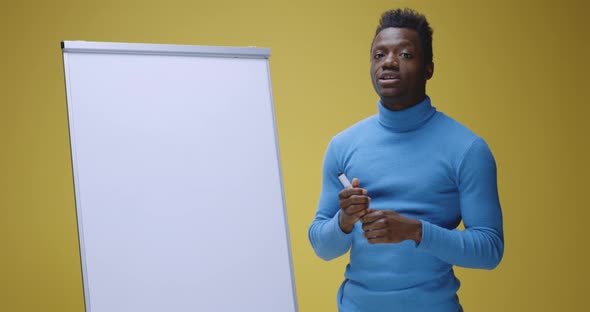 Young Man Teaching Language with Flipchart alt