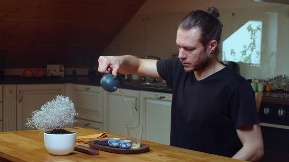Caucasian Man Brewing Green Tea Oolong Indoors at Home Kitchen Slow Motion