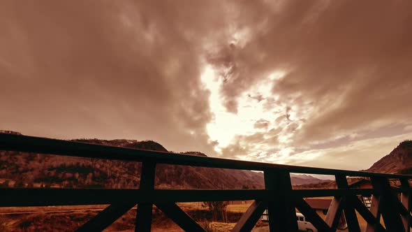 Timelapse of Wooden Fence on High Terrace at Mountain Landscape with Clouds. Horizontal Slider alt