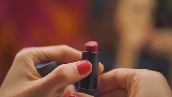 Red Lipstick in Girls Beautiful Hands Makeup
