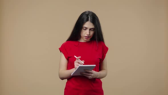 Portrait of Beauty Model Thinking with Concentration Writing Ideas in Notebook alt