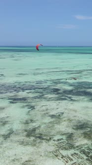 Vertical Video Kitesurfing Near the Shore of Zanzibar Tanzania alt