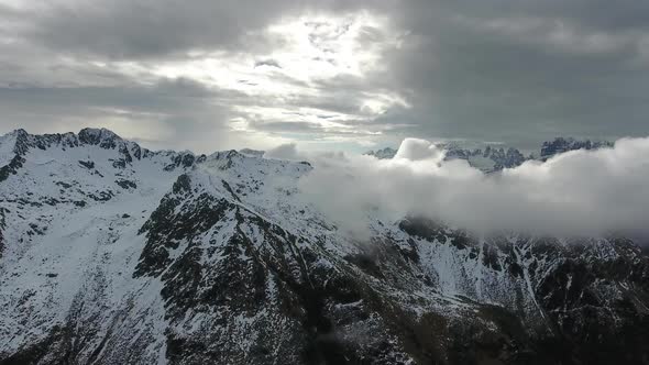 Flying Through Clouds Between Mountains alt