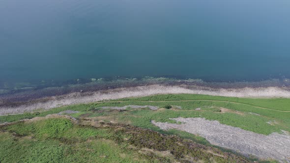 Flying Along the Coast of the Holy Isle in Scotland with Beautiful Mountains alt