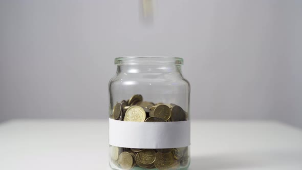 Coins in a Jar with Blank White Label.