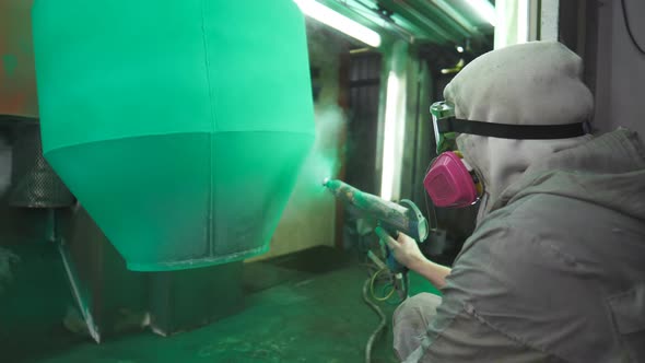 Painter Spraying Green Paint on Detail in Special Booth alt