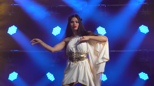 Girl Dance in Greek Greece Goddes Dress and Wreath High Fashion. Young Hot Brunette with Long Hair alt