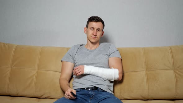 Man with Broken Spokebone Switches TV By Remote Controller alt