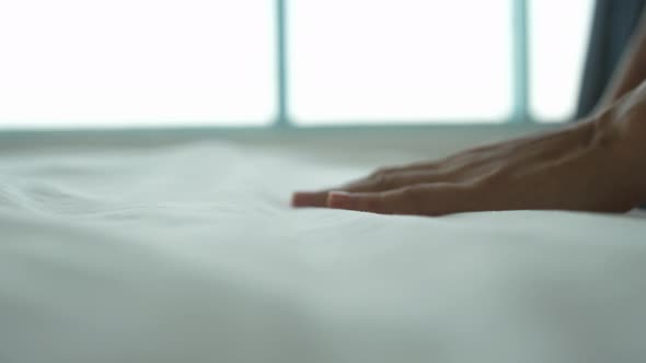 Hand of a Woman Touches Very Soft and Clean Bed Linen