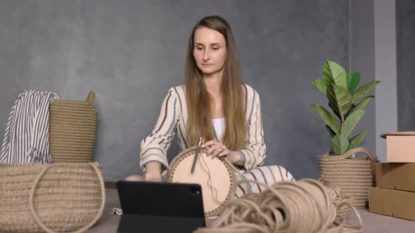 Young Woman Watching Online Lessons or Tutorialson Laptop and Learning How to Crochet, 4k
