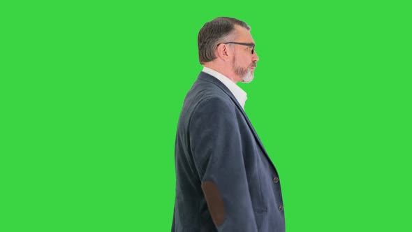 Senior Business Man Walking Forward on a Green Screen Chroma Key alt