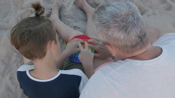 Child Involving Grandpa in Popit Playing alt